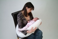 dream genii support pillow woman holding baby in feeding mode